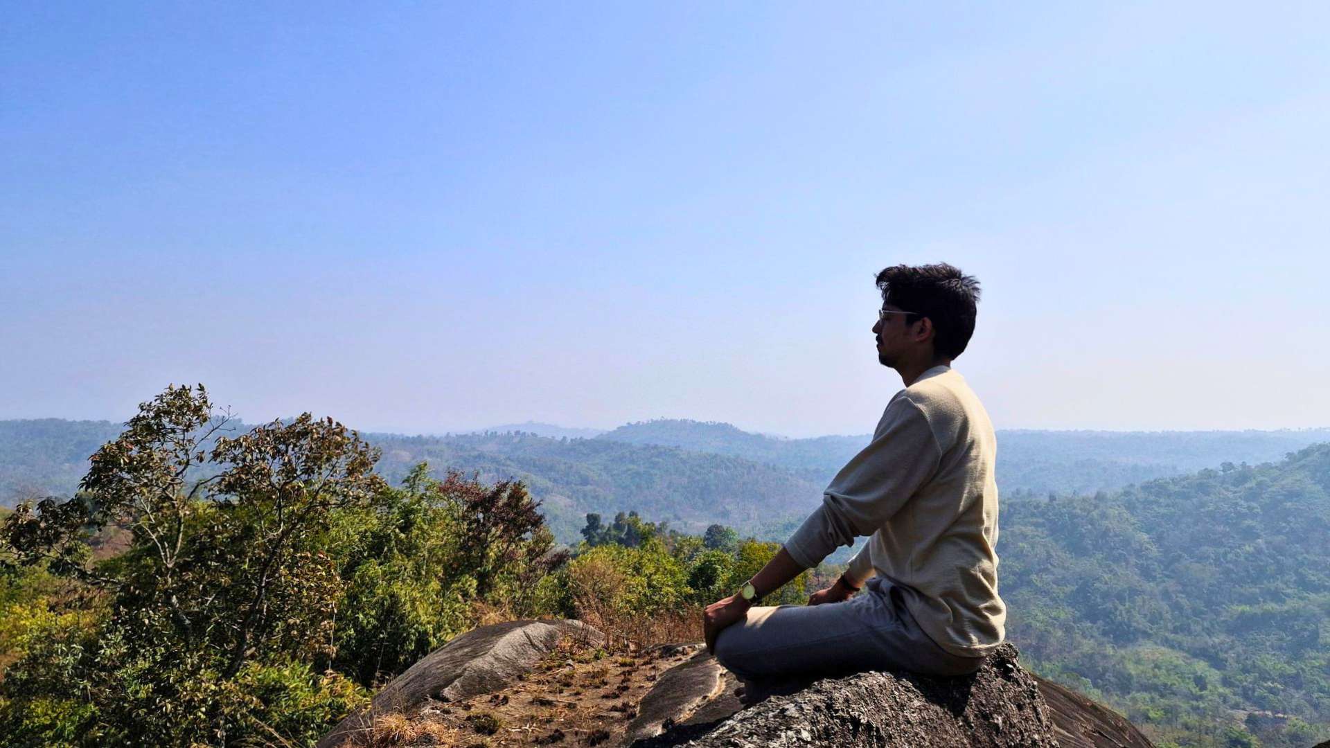 Person meditating on Balakhangor Peak in Umswai Valley, Assam